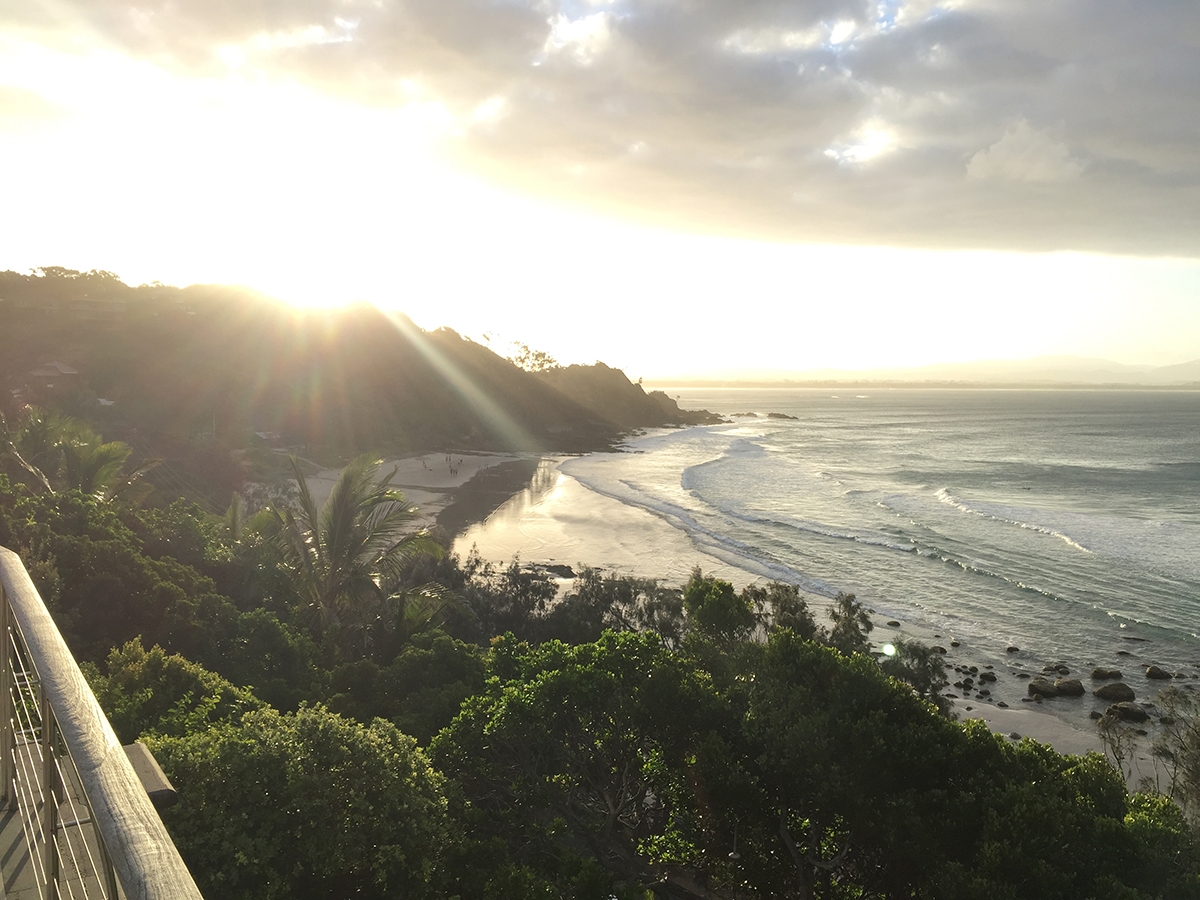 The view of the sunset behind Wategos beach from atop a mountain  