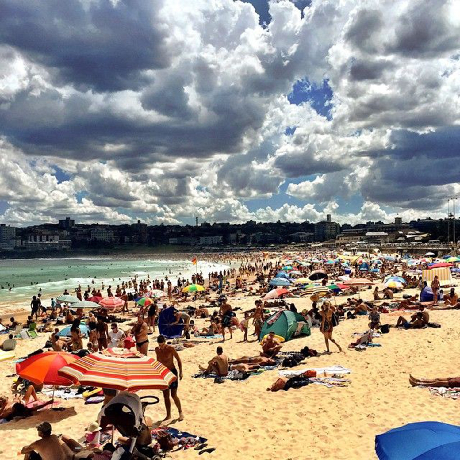 North Bondi filled with swimmers, sunbathers and beachgoers enjoying the sunshine 