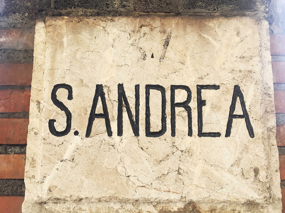 A hand painted sign that reads ‘S.ANDREA’ 