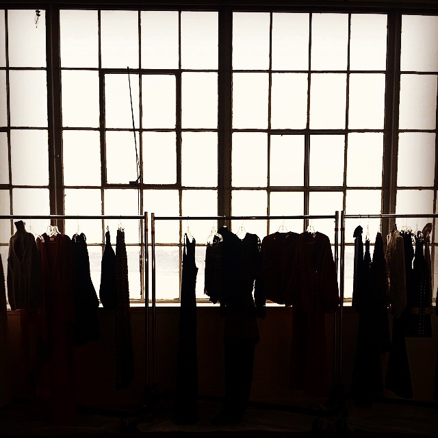 Garment racks by a window in preparation for NYFW