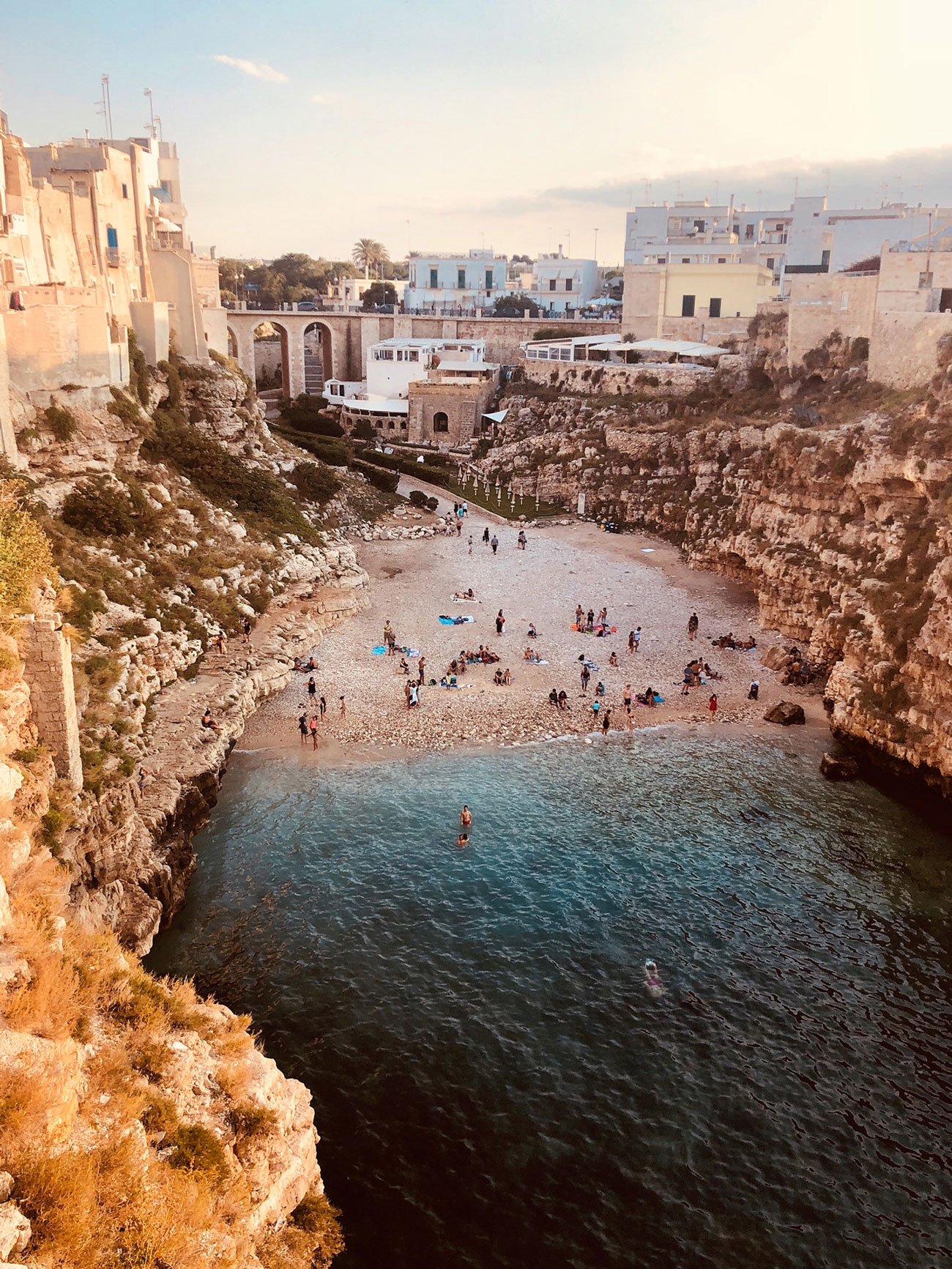 A sunset swim in a small cove surrounded by the clifftop town of Polignano de Mare
